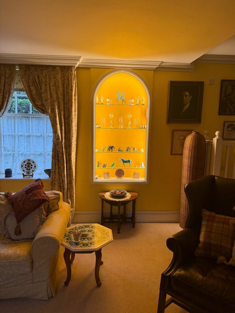 Soft lighting in arch shaped feature display cabinet without any lighting directly hitting the eyes.