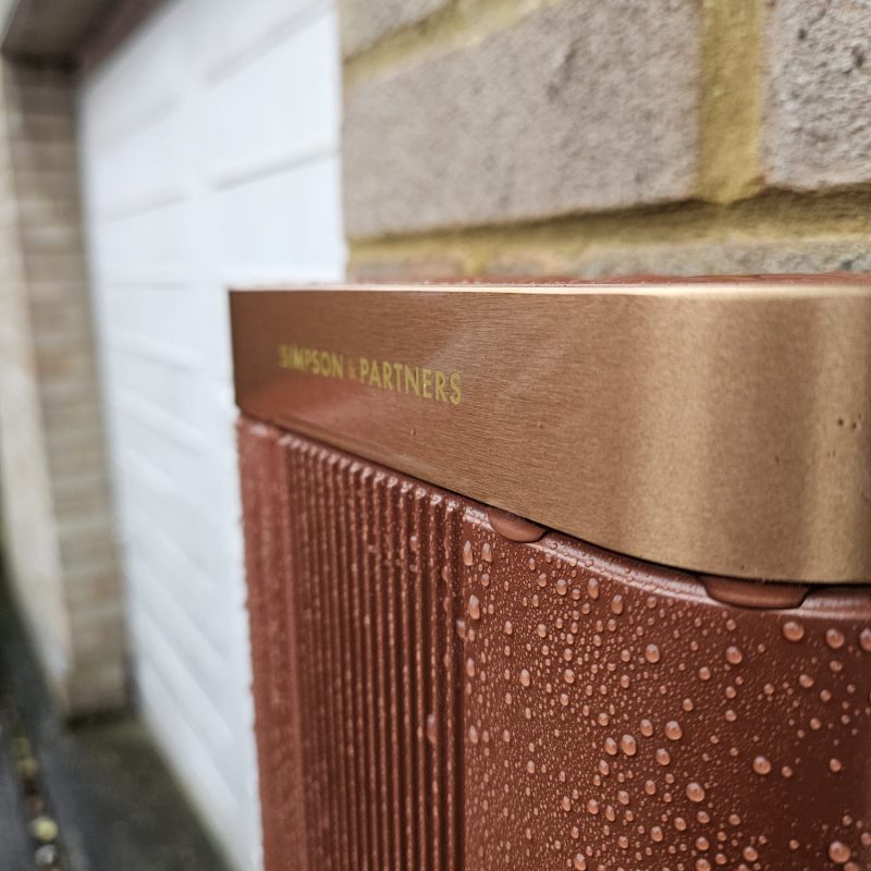 Brushed copper catching the light, with the garage door beyond