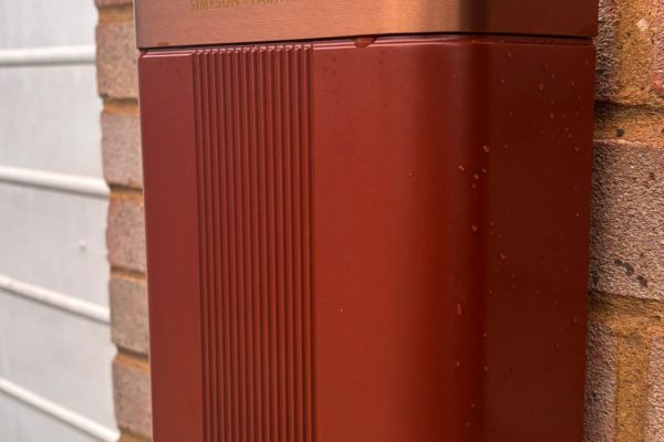 The unit reads warm against the red brick, garage door to one side