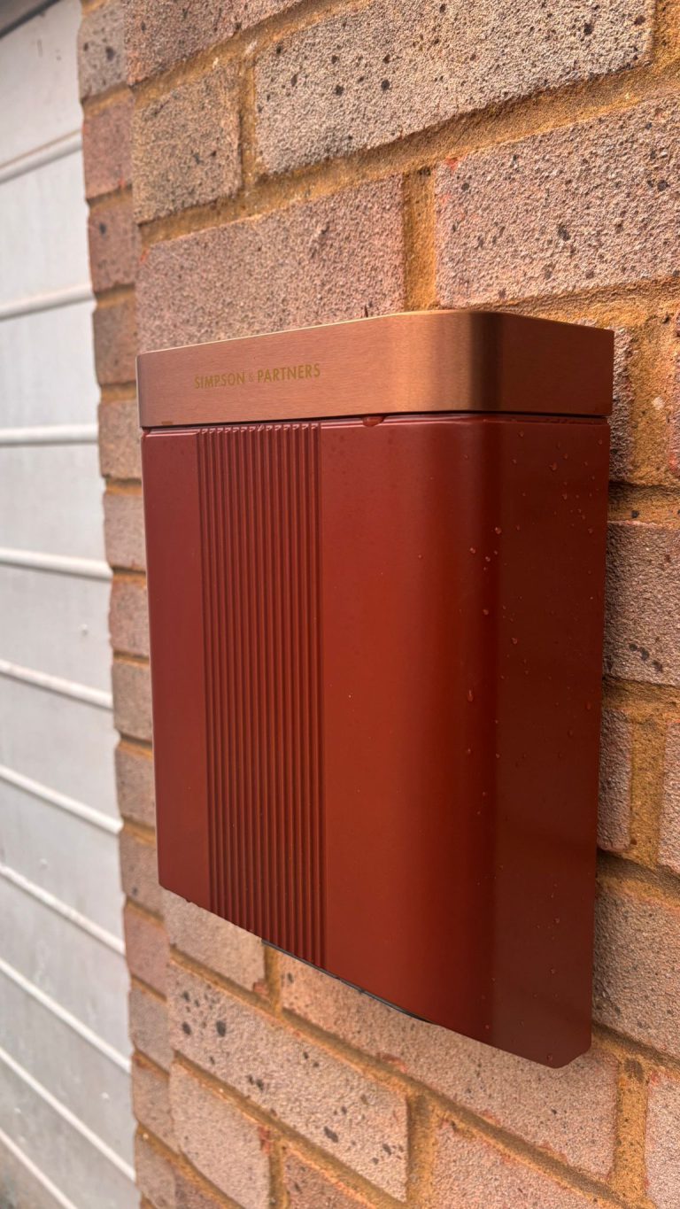 The unit reads warm against the red brick, garage door to one side