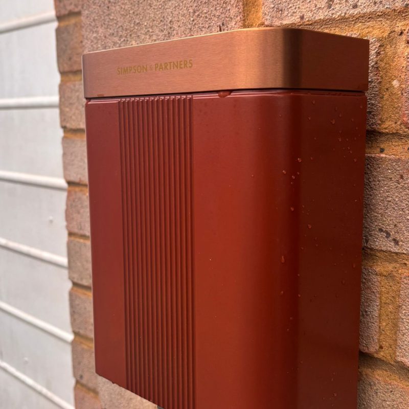 The unit reads warm against the red brick, garage door to one side