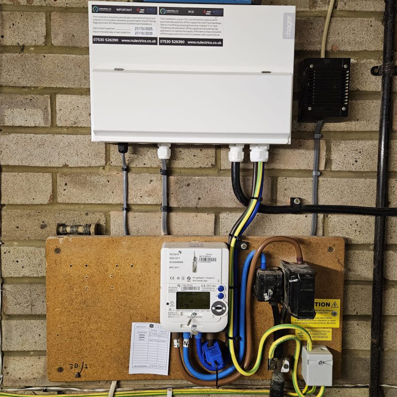 Levelled, labelled and wired, with the main earth dropping to the meter board