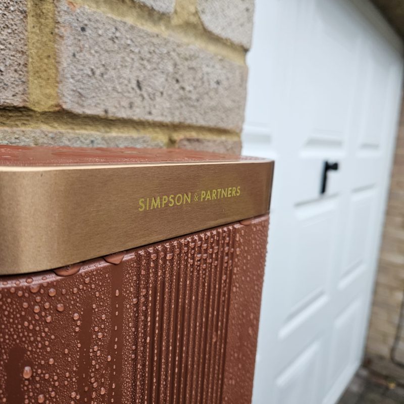 Rain on the fluted body, the brand engraved into the brushed copper lid