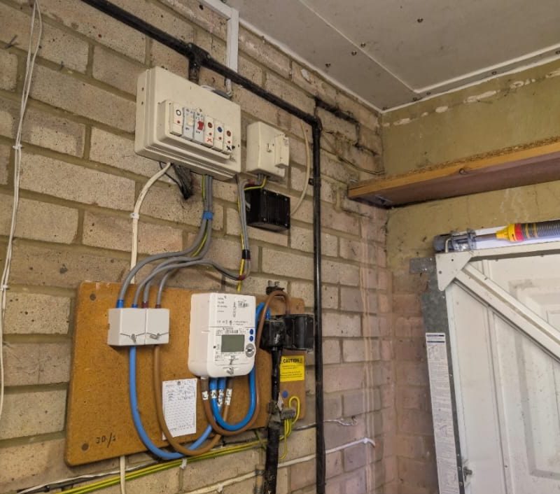 How the garage supply looked beforehand, the old board sitting above the meter