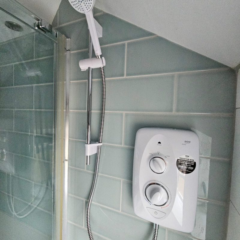 The finished Mira shower, handset and riser rail back on the tiled wall