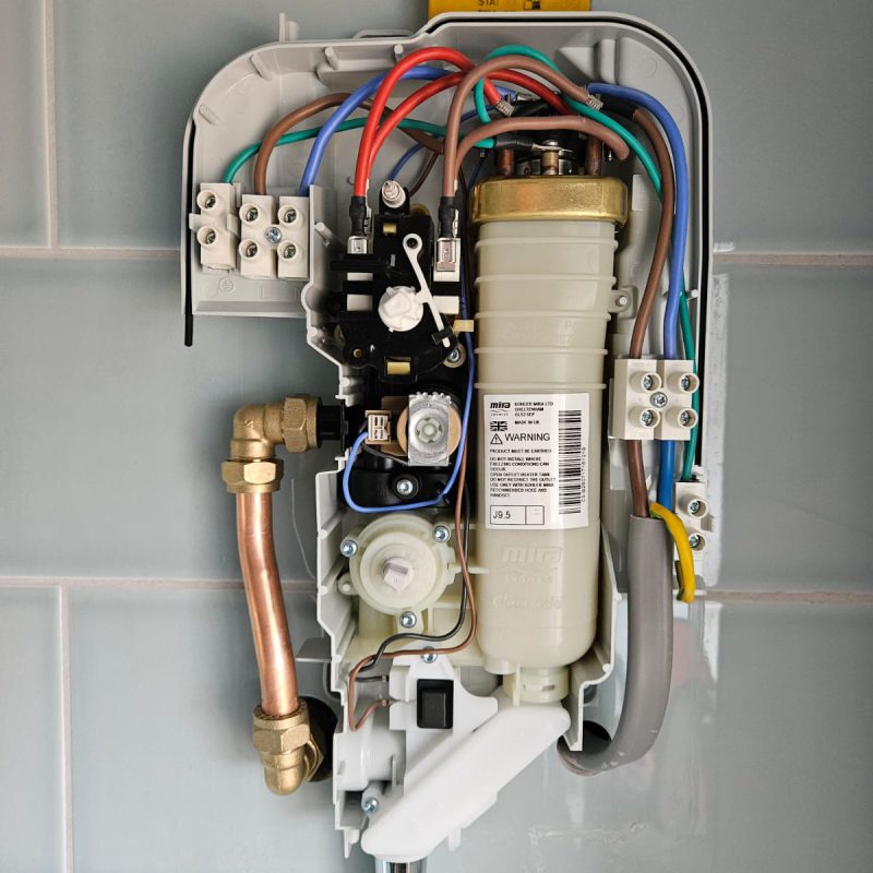 Inside the 9.5kW unit before the cover goes on, copper tails into the inlet elbow