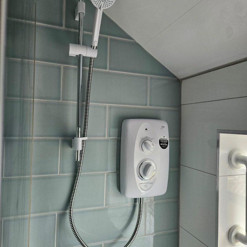 The new shower from the doorway, riser rail and hose neatly clipped