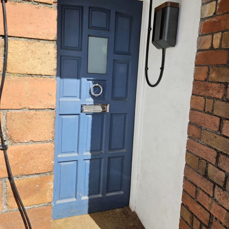 Mounted inside the porch, clear of the pavement outside