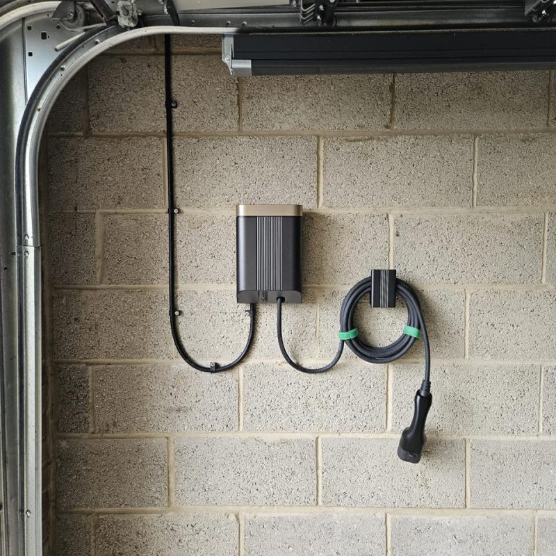 Tethered lead coiled on its hook beside the black and bronze unit